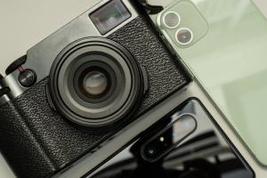 Digitalkamera liegt neben Smartphone-Kameras